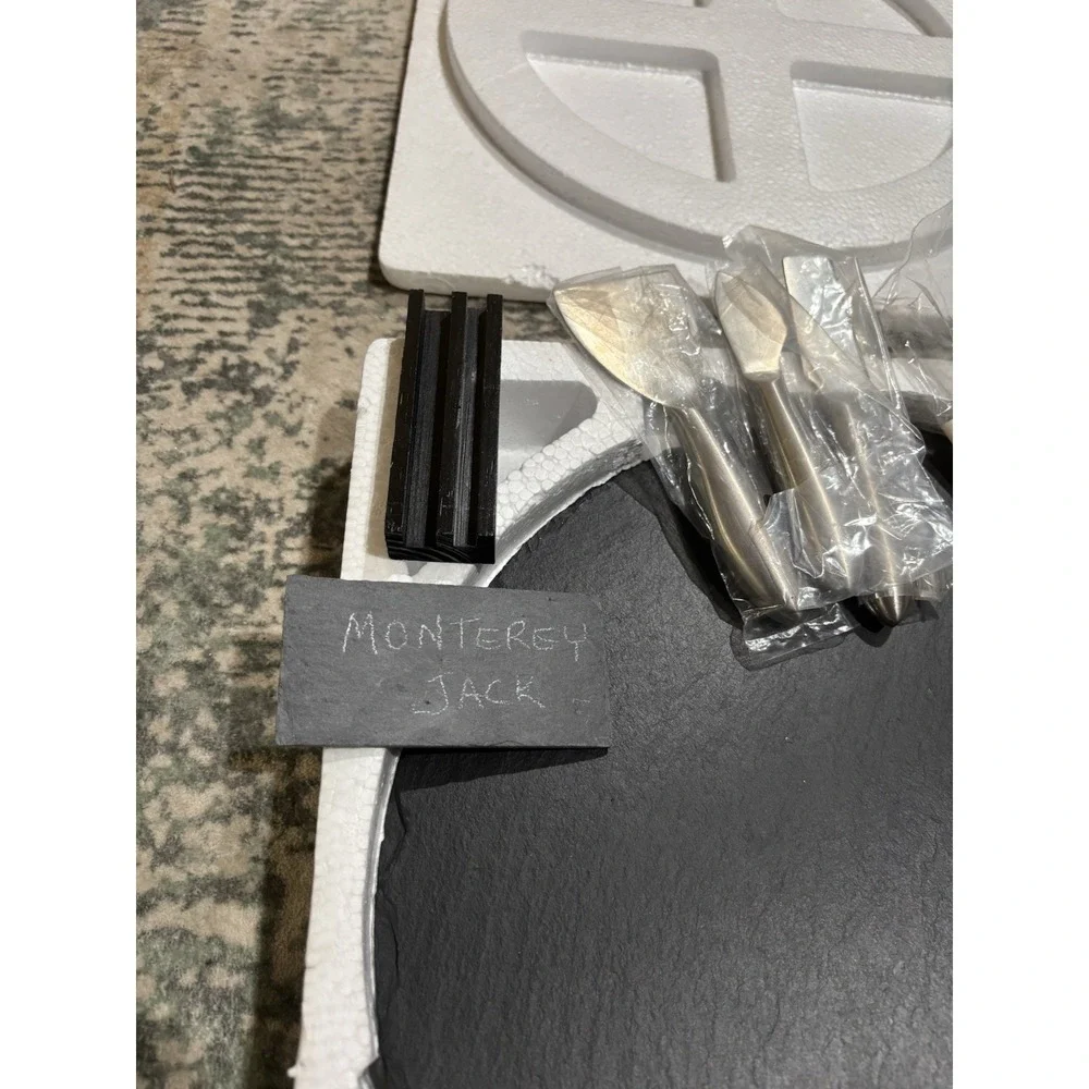 Large Slate Charcuterie Board On A Lazy Susan With Serving Utensils And Placards